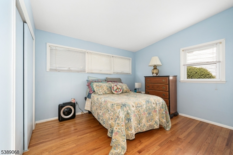 53 White Meadow Road Rockaway, NJ 07866 - Photo 12 of 40 a bedroom with a bed and wooden floor