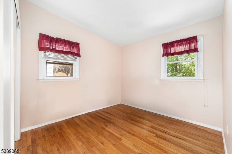 53 White Meadow Road Rockaway, NJ 07866 - Photo 14 of 40 a view of an empty room with wooden floor and a window