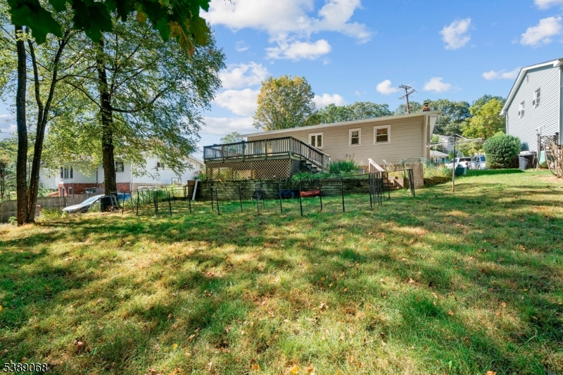 53 White Meadow Road Rockaway, NJ 07866 - Photo 17 of 40 a view of a backyard with plants and large tree