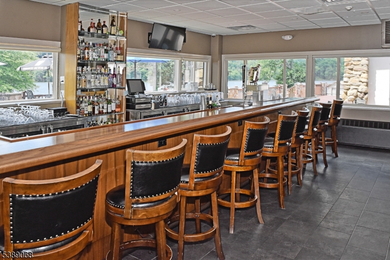 53 White Meadow Road Rockaway, NJ 07866 - Photo 23 of 40 a kitchen with a dining table chairs and large windows