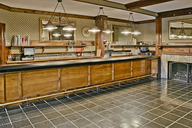 a view of a kitchen with granite countertop a sink a stove and cabinets