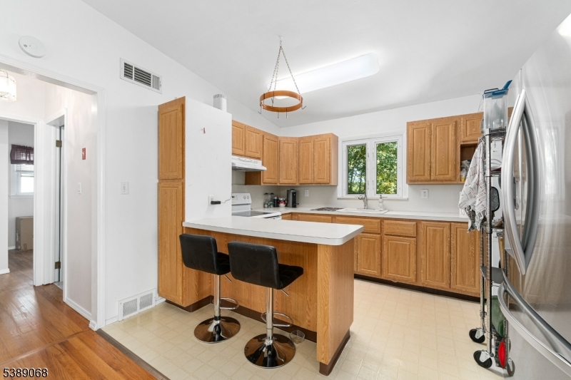 53 White Meadow Road Rockaway, NJ 07866 - Photo 6 of 40 a kitchen with stainless steel appliances granite countertop a sink a stove a refrigerator and island