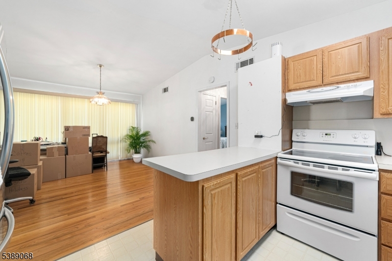 53 White Meadow Road Rockaway, NJ 07866 - Photo 8 of 40 a kitchen with a stove cabinets and wooden floor