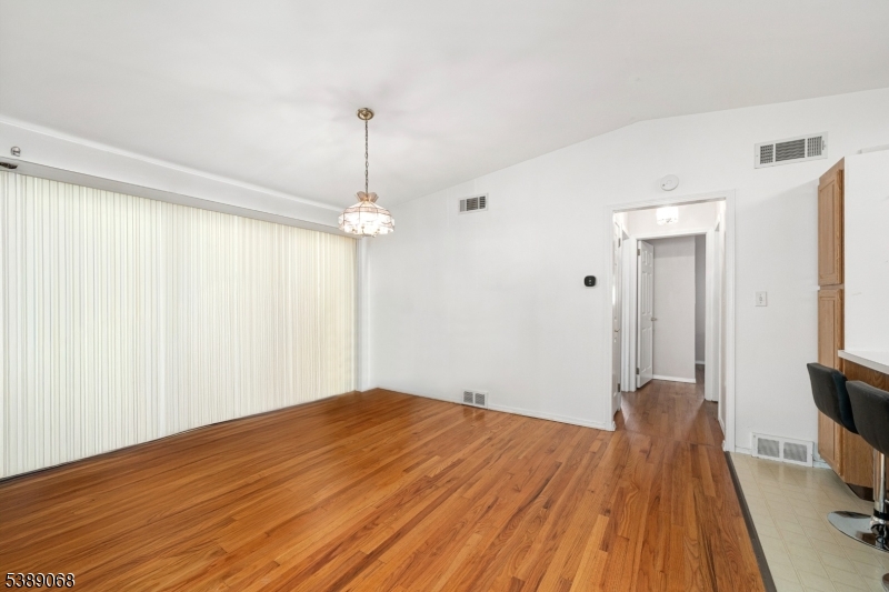 53 White Meadow Road Rockaway, NJ 07866 - Photo 10 of 40 a view of a room with wooden floor and ceiling fan