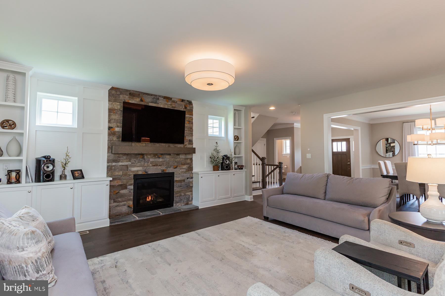 425 East Delp Road Lancaster, PA 17601 - Photo 28 of 109 a living room with furniture a fireplace and a flat screen tv