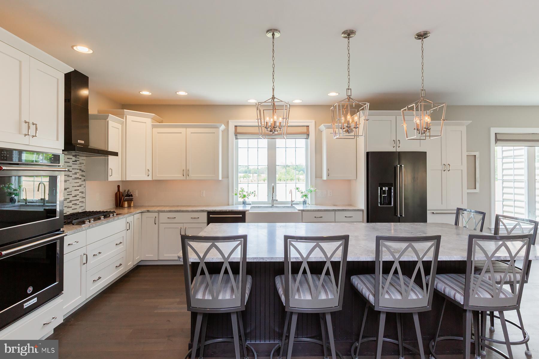 425 East Delp Road Lancaster, PA 17601 - Photo 34 of 109 a kitchen with stainless steel appliances kitchen island granite countertop a table and chairs in it