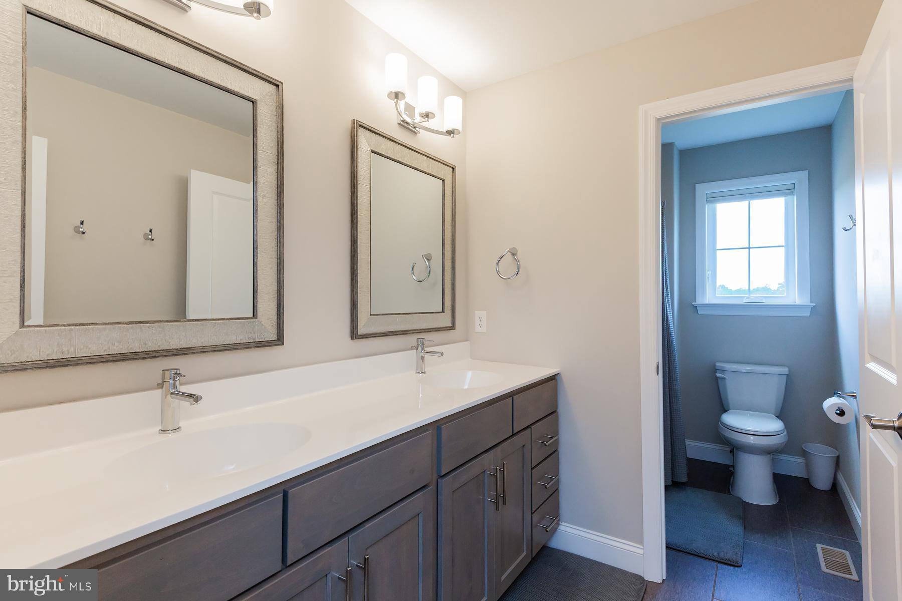 425 East Delp Road Lancaster, PA 17601 - Photo 74 of 109 a bathroom with a toilet a sink and mirror