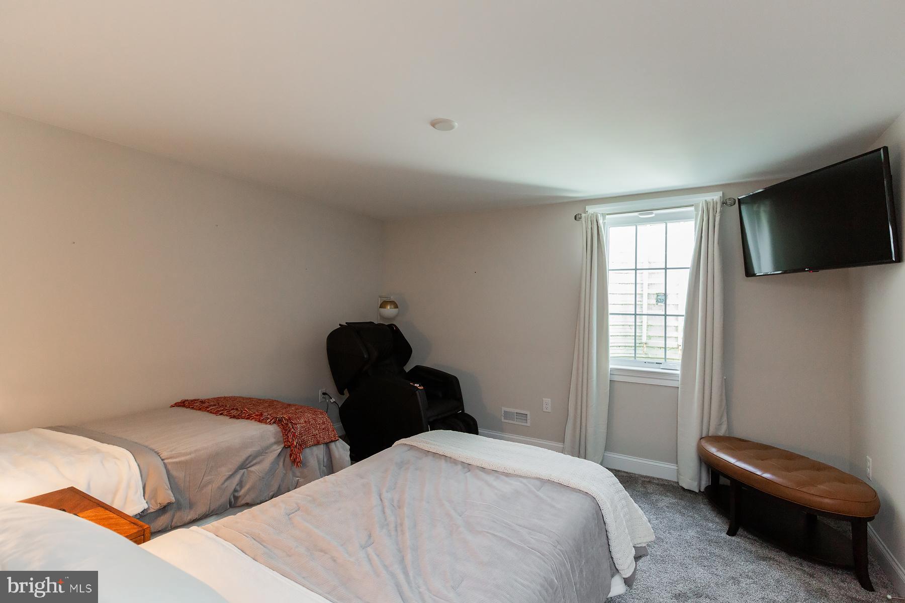 425 East Delp Road Lancaster, PA 17601 - Photo 90 of 109 a bedroom with two beds and a flat screen tv