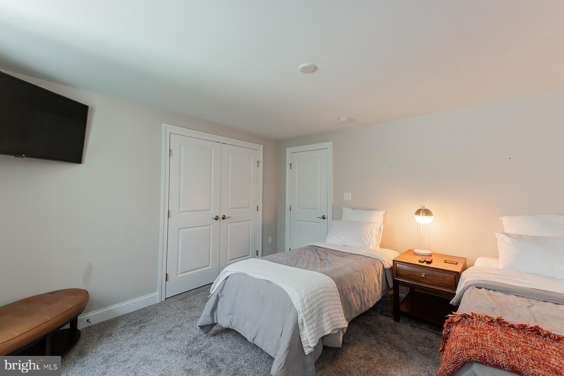 425 East Delp Road Lancaster, PA 17601 - Photo 91 of 109 a spacious bedroom with a bed and a television