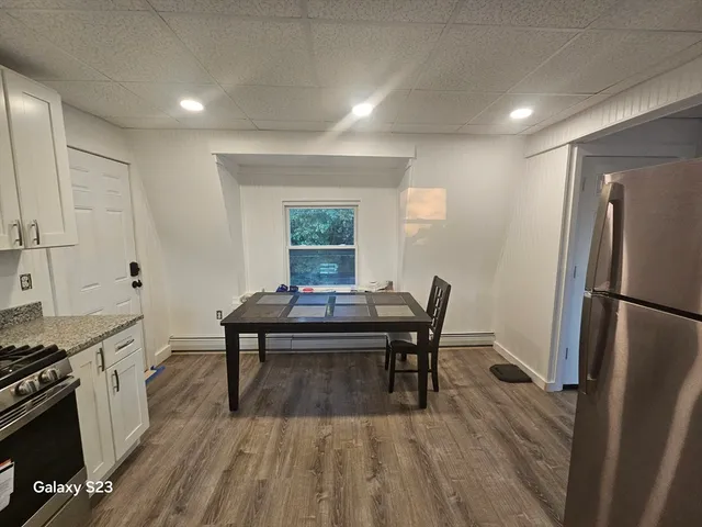 a view of a kitchen with a table and chairs
