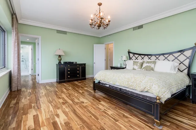 a bedroom with a bed and a chandelier