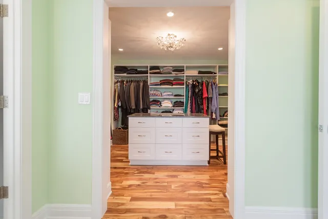 a view of walk in closet with clothes