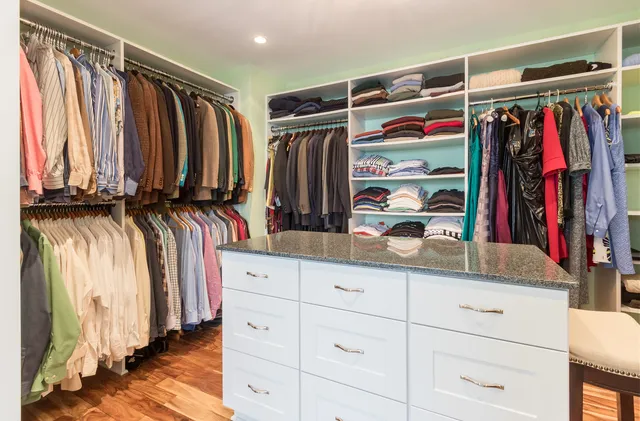a view of walk in closet with clothes