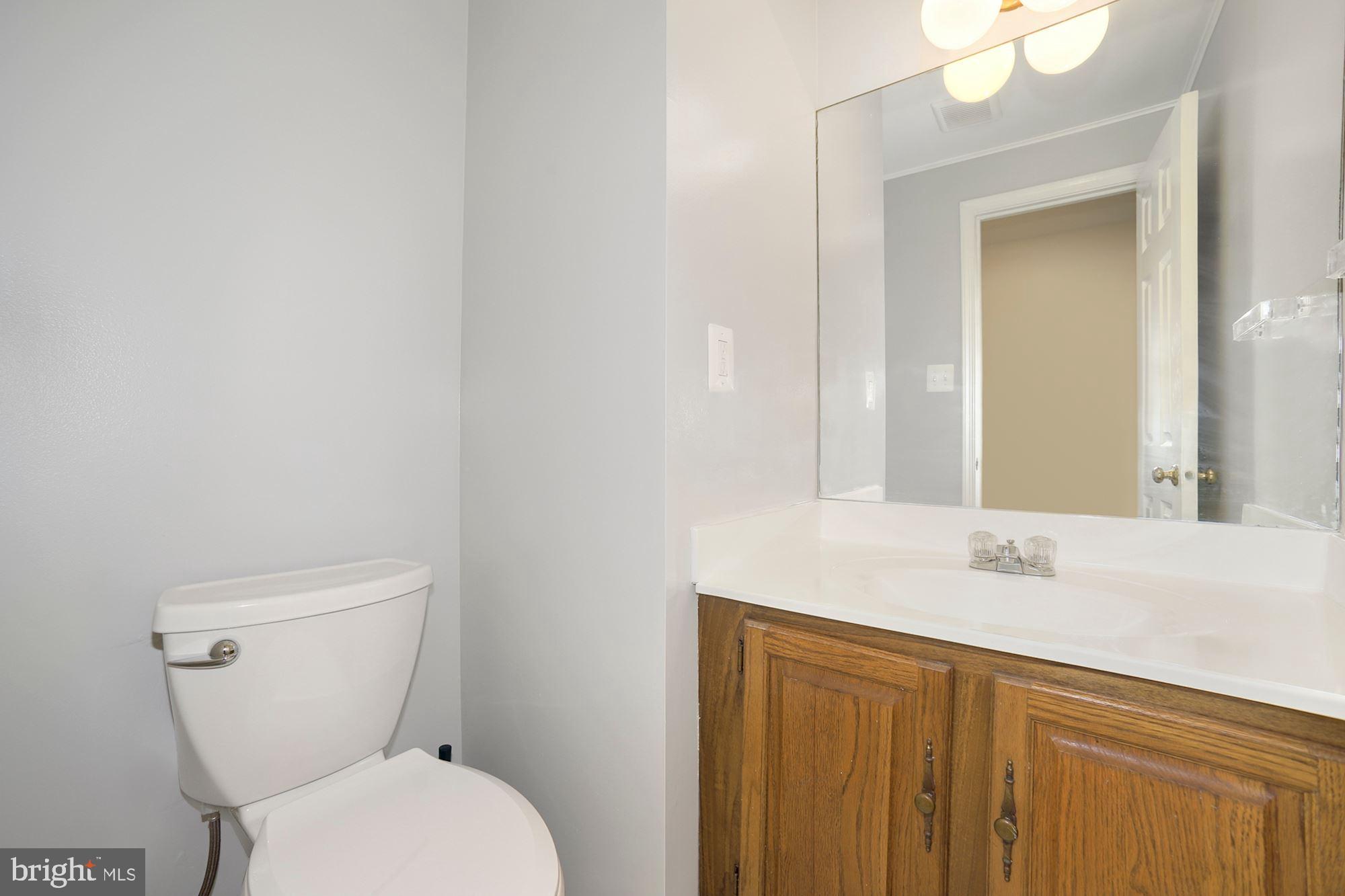 10107 Galsworthy Place Bethesda, MD 20817 - Photo 14 of 62 a bathroom with a toilet sink and mirror