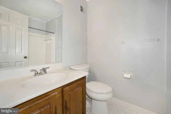 a view of a kitchen with a refrigerator a stove top oven and wooden floor