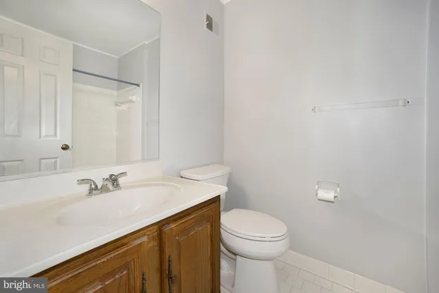 a view of a kitchen with a refrigerator a stove top oven and wooden floor