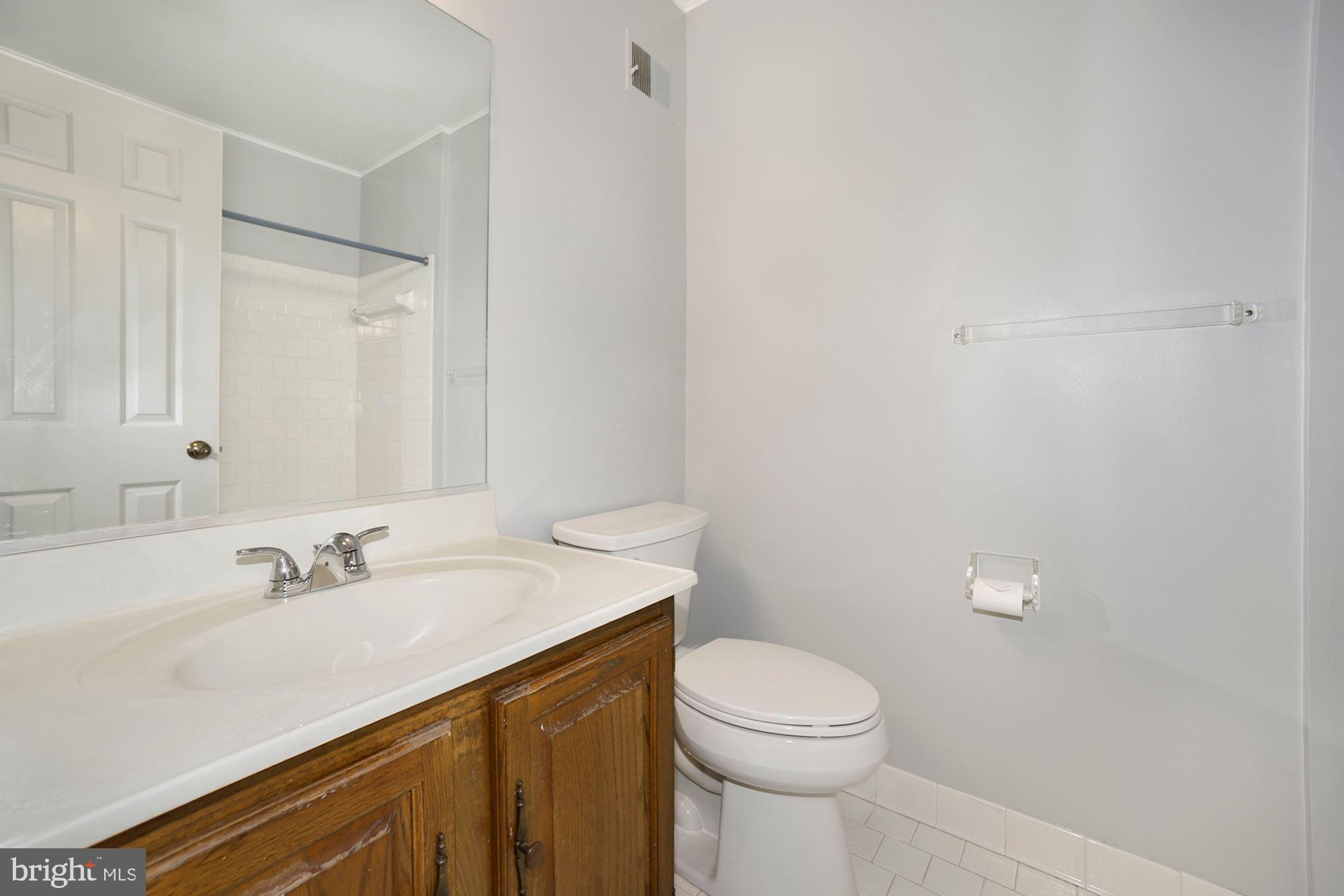 10107 Galsworthy Place Bethesda, MD 20817 - Photo 15 of 62 a bathroom with a sink a toilet and a mirror