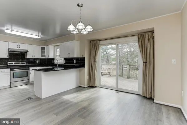 a kitchen with granite countertop a refrigerator sink and stove