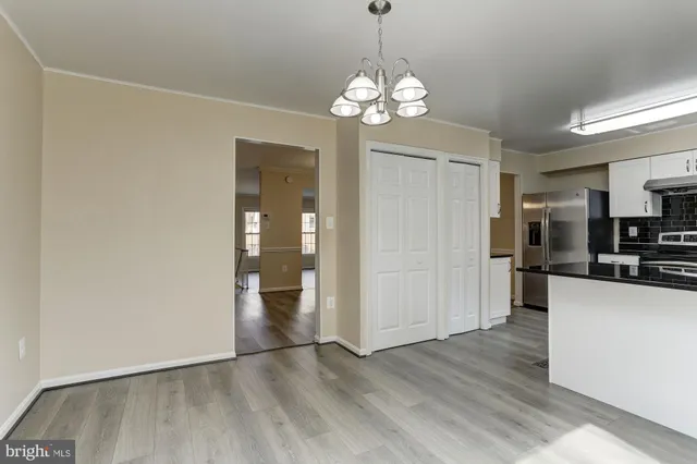 a kitchen with stainless steel appliances a stove a sink and a refrigerator