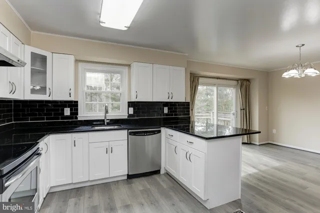 a view of an empty room with a window and a ceiling fan