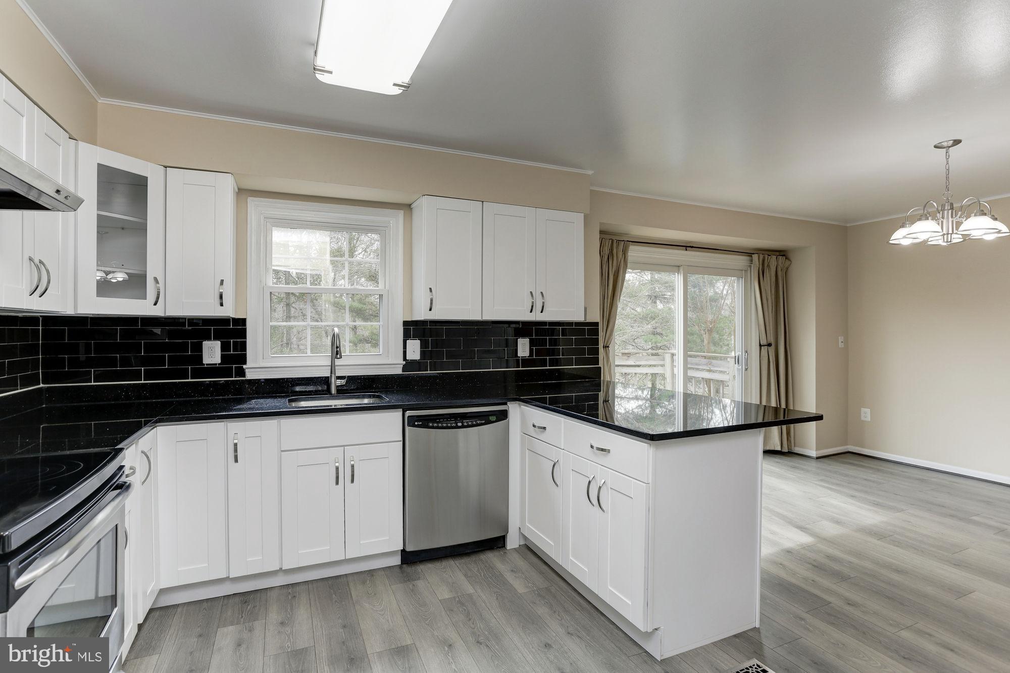 10107 Galsworthy Place Bethesda, MD 20817 - Photo 23 of 62 a kitchen with granite countertop a sink and cabinets