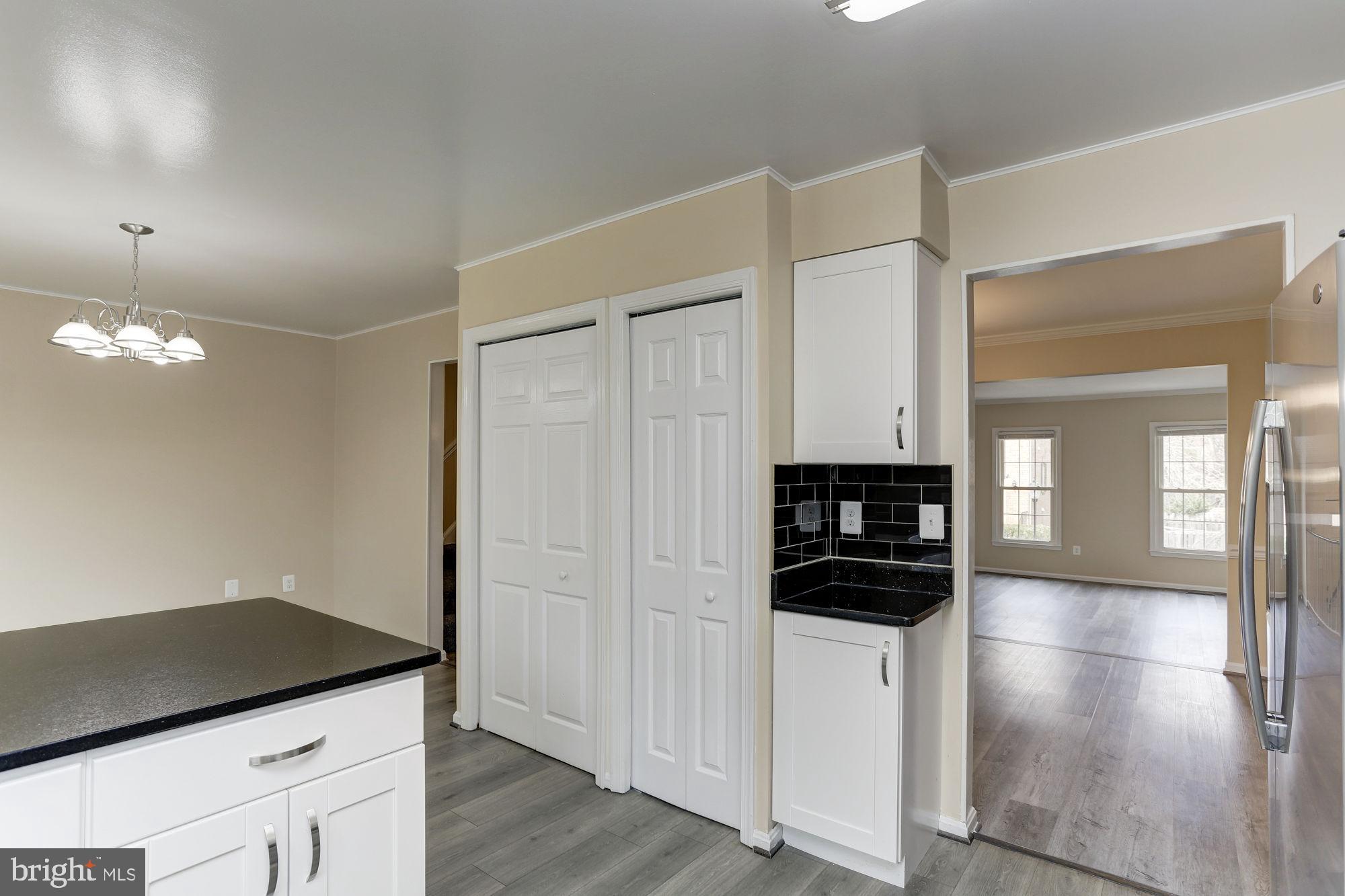 10107 Galsworthy Place Bethesda, MD 20817 - Photo 25 of 62 a kitchen view with stainless steel appliances a refrigerator and a stove top oven