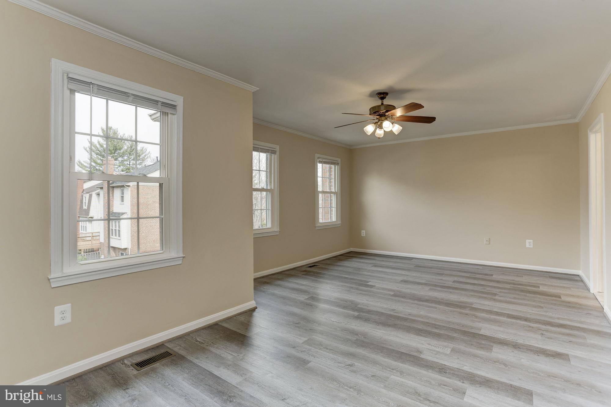 10107 Galsworthy Place Bethesda, MD 20817 - Photo 27 of 62 a view of an empty room with a window and a ceiling fan