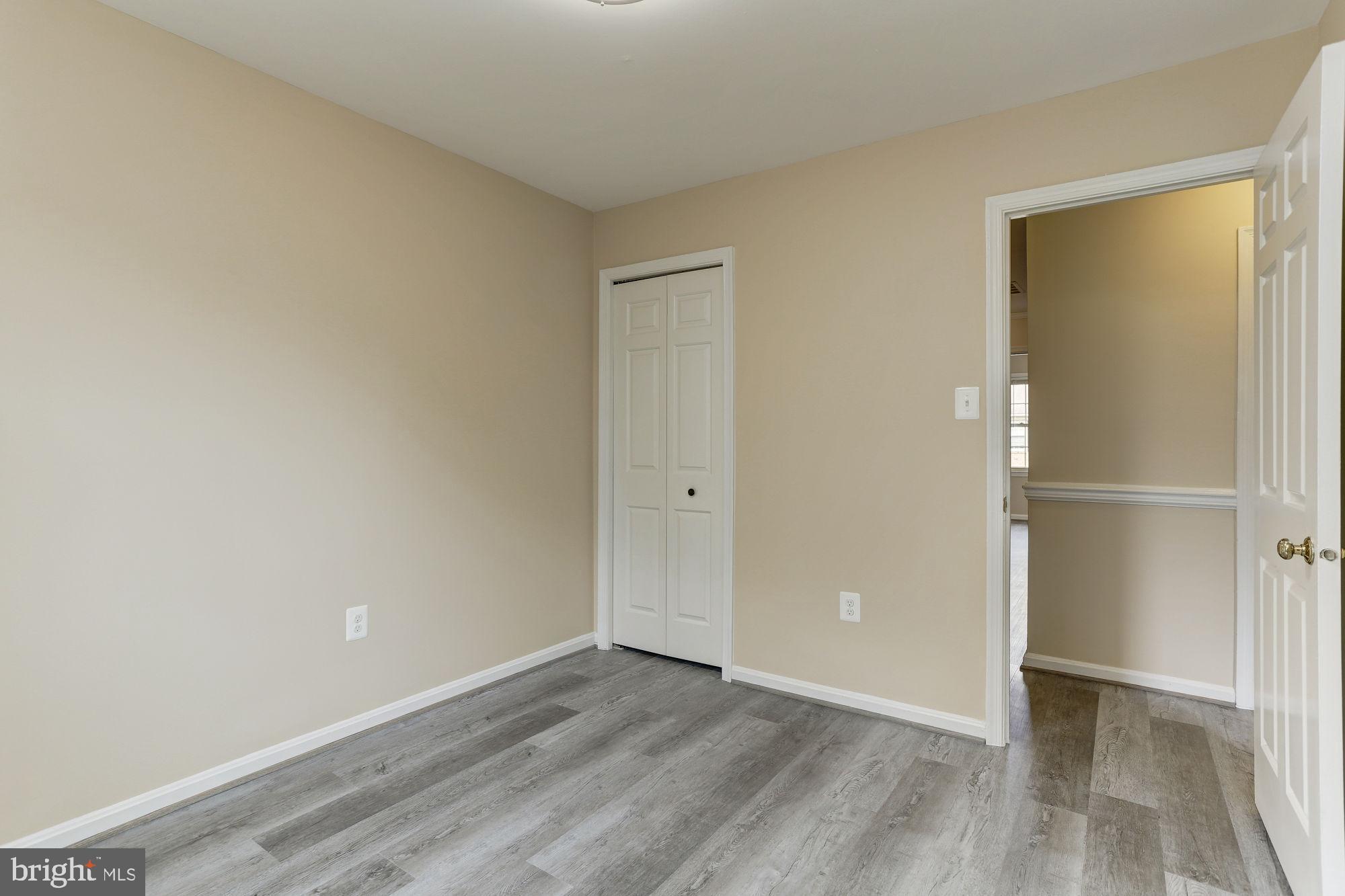 10107 Galsworthy Place Bethesda, MD 20817 - Photo 36 of 62 an empty room with wooden floor and closet area