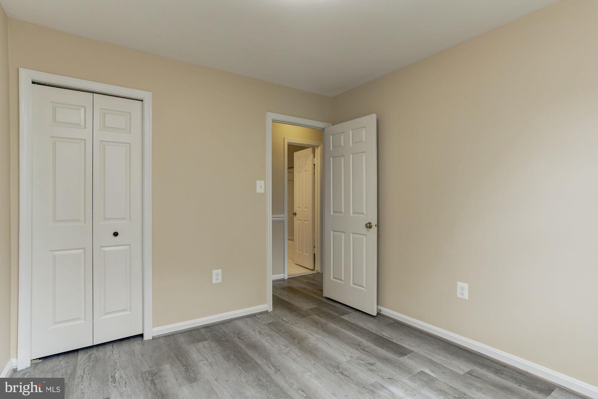 10107 Galsworthy Place Bethesda, MD 20817 - Photo 37 of 62 a view of an empty room and wooden floor