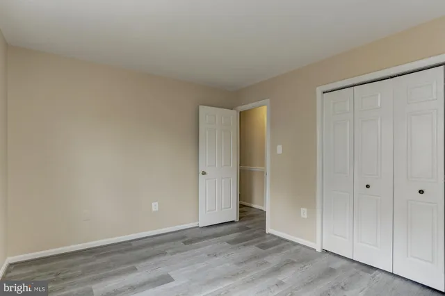 a bathroom with a granite countertop toilet sink and mirror