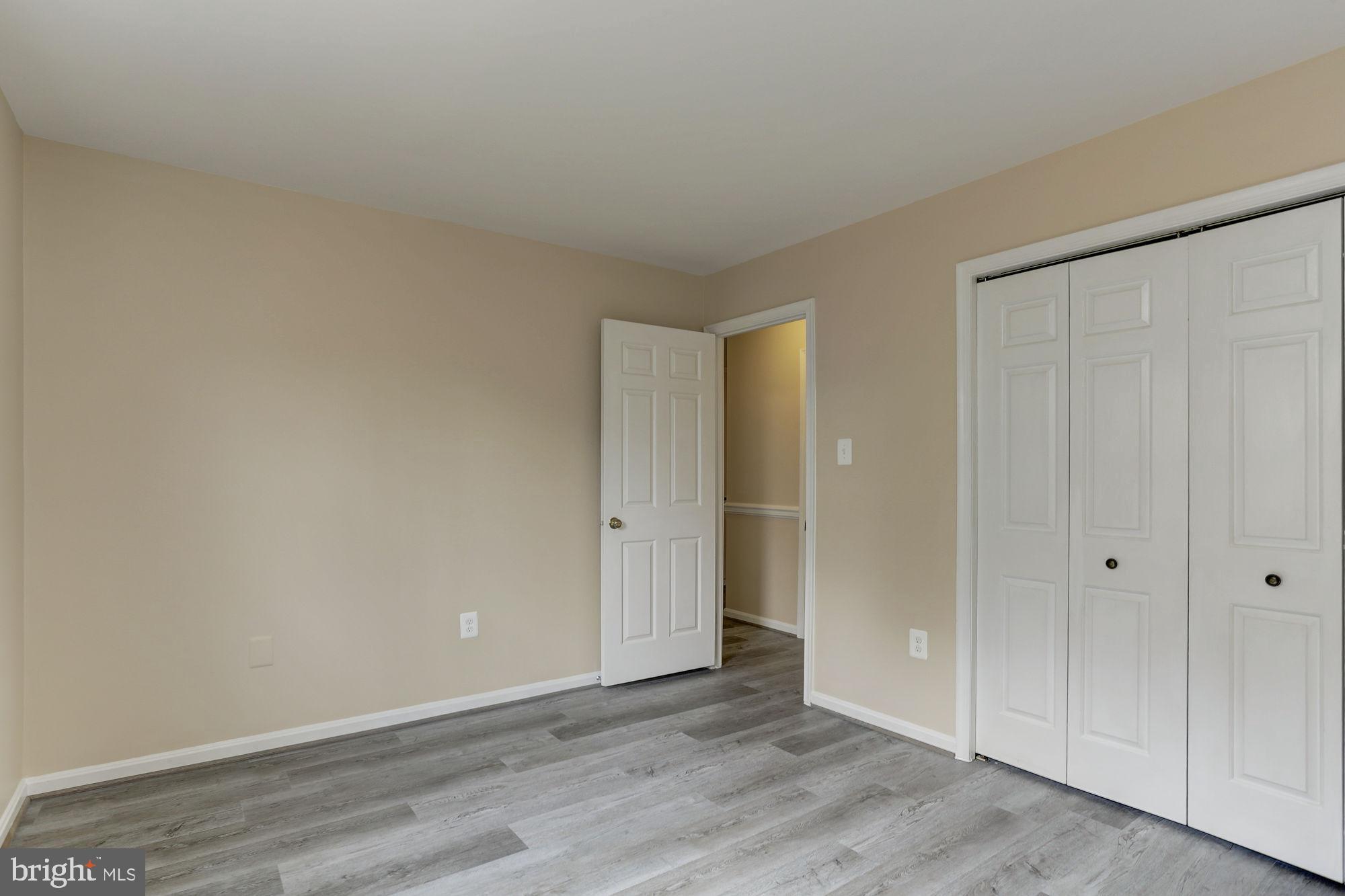 10107 Galsworthy Place Bethesda, MD 20817 - Photo 41 of 62 a view of an empty room with wooden floor