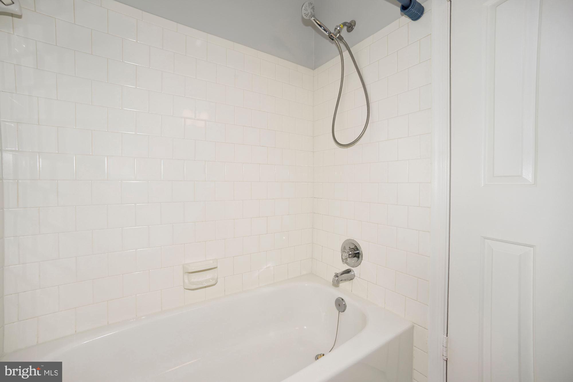 10107 Galsworthy Place Bethesda, MD 20817 - Photo 43 of 62 a bathroom with a bath tub with a shower