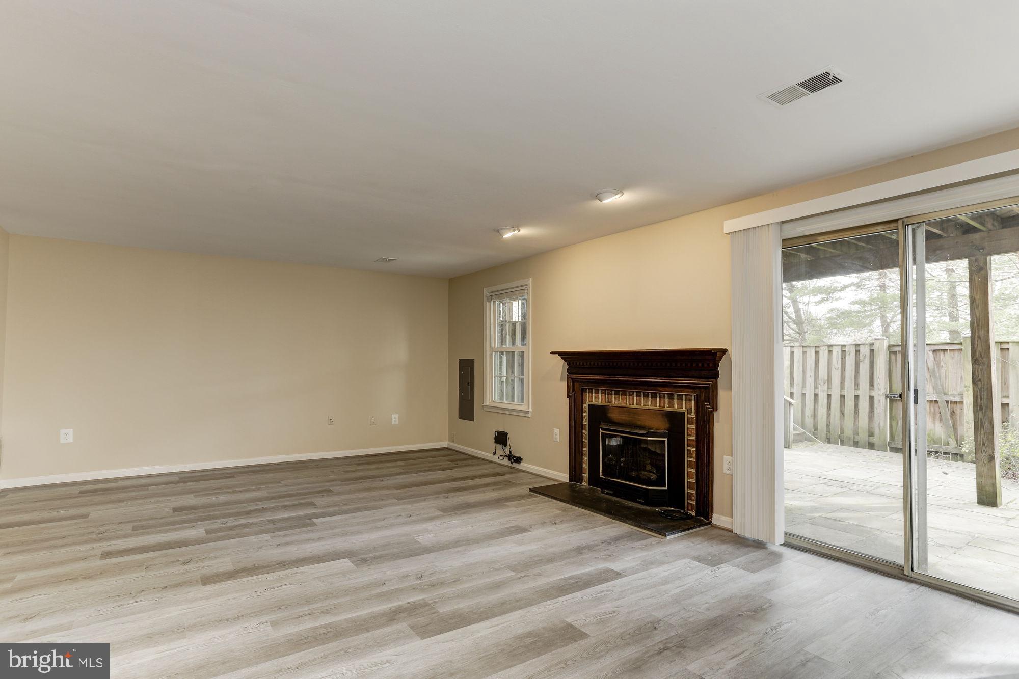 10107 Galsworthy Place Bethesda, MD 20817 - Photo 44 of 62 wooden floor fireplace and natural light in room