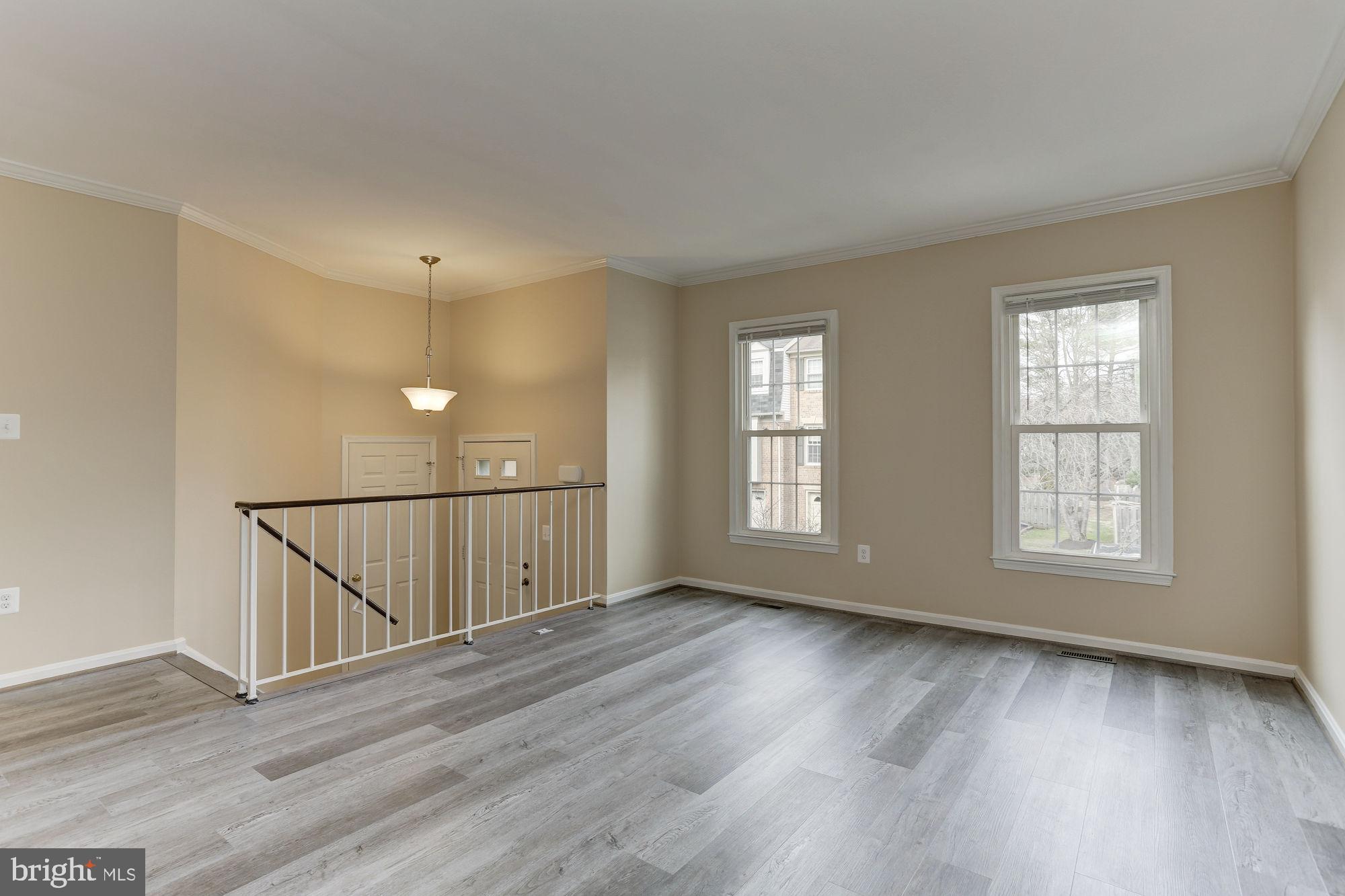10107 Galsworthy Place Bethesda, MD 20817 - Photo 6 of 62 an empty room with wooden floor and windows