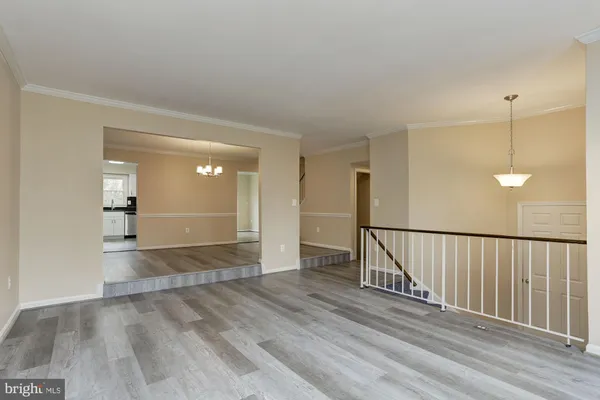 a view of a room with wooden floor and stairs
