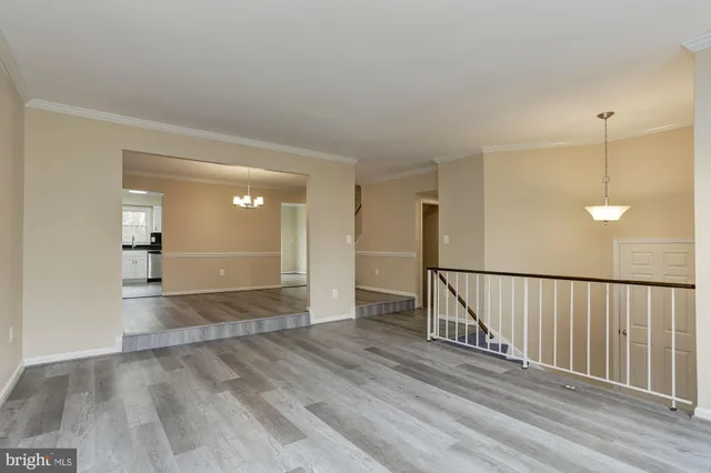 a view of a room with wooden floor and stairs
