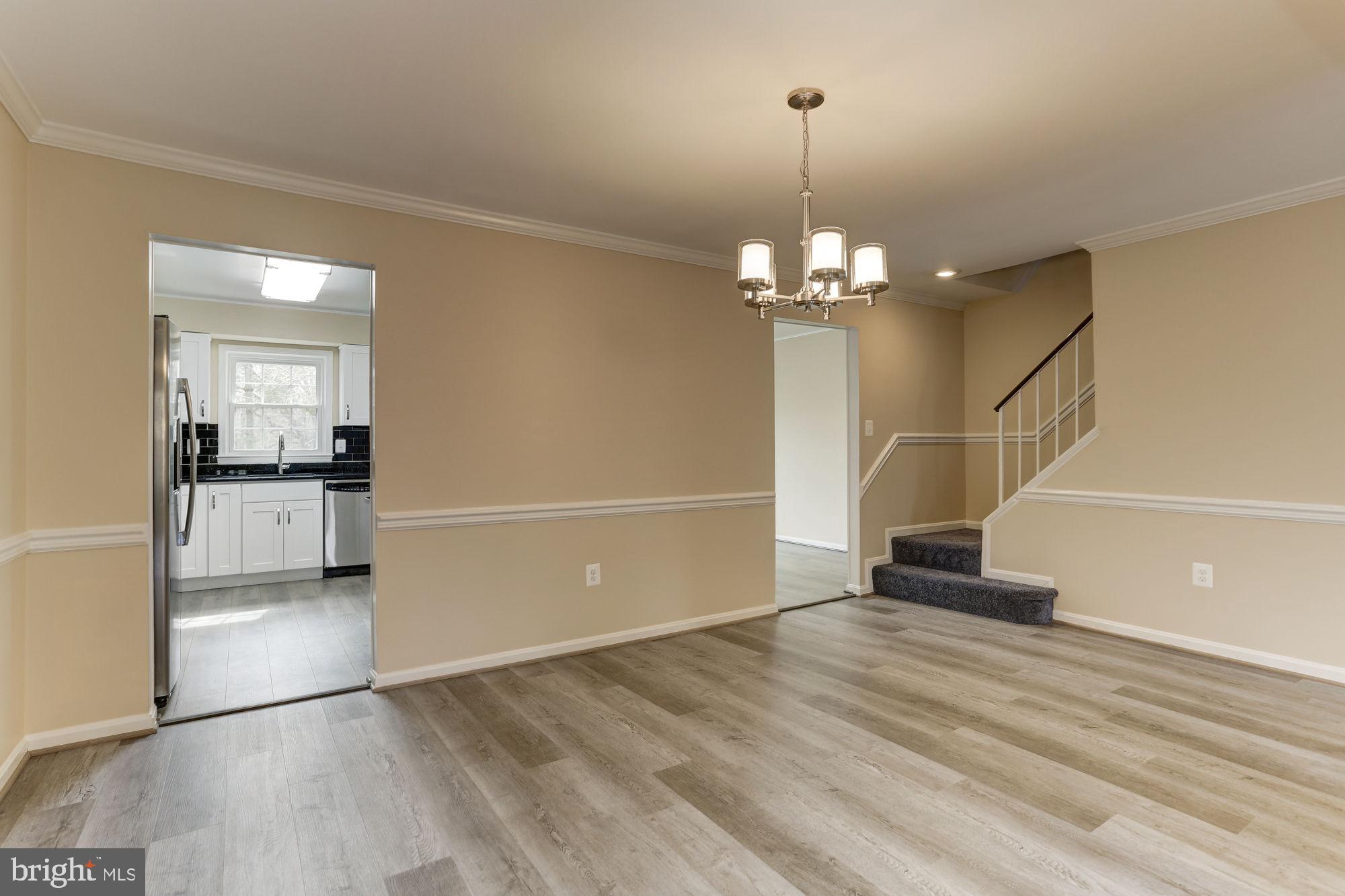 10107 Galsworthy Place Bethesda, MD 20817 - Photo 8 of 62 a view of a room with wooden floor and stairs