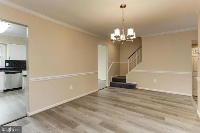 a view of a livingroom with a chandelier fan