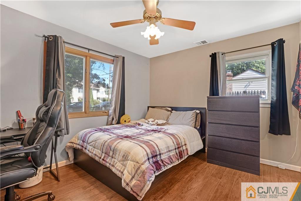 10 Crescent Road Edison, NJ 08817 - Photo 12 of 33 a bedroom with a bed and a chandelier