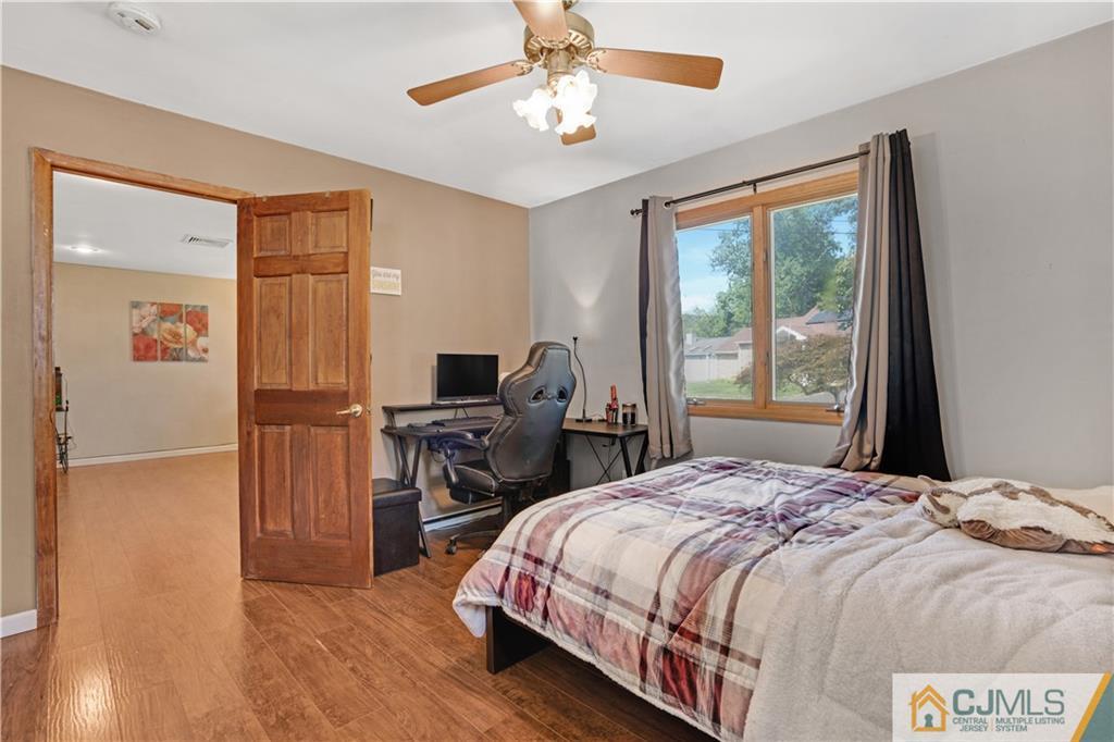 10 Crescent Road Edison, NJ 08817 - Photo 13 of 33 a bedroom with a bed and a chandelier