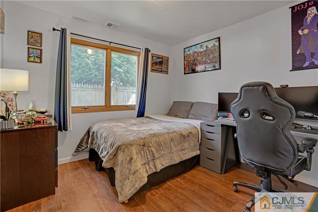 10 Crescent Road Edison, NJ 08817 - Photo 14 of 33 a bedroom with a bed and wooden floor