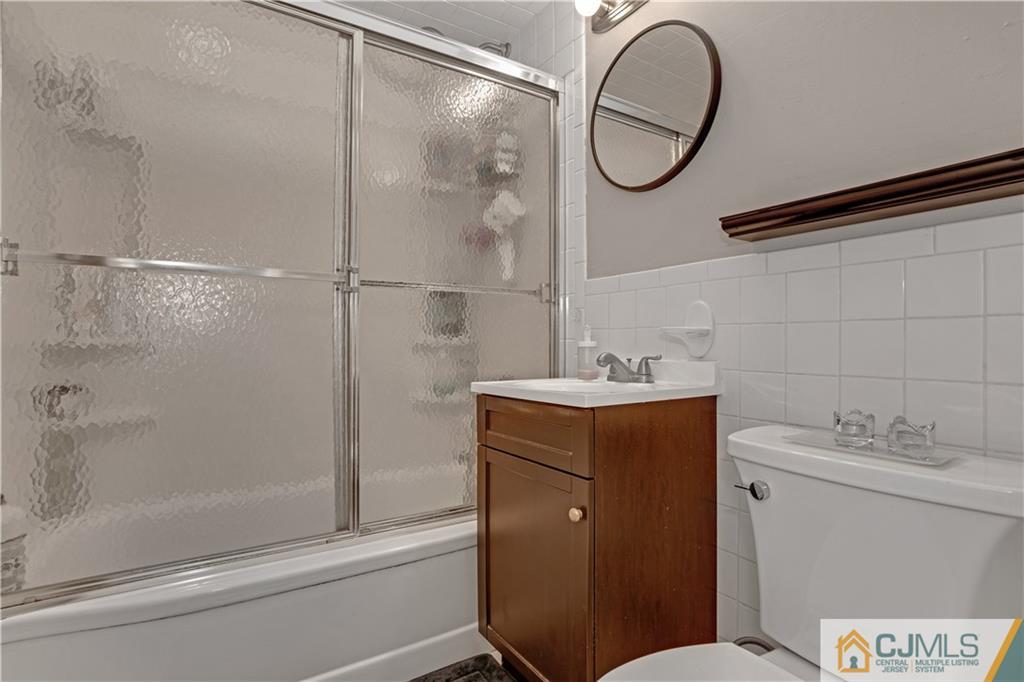 10 Crescent Road Edison, NJ 08817 - Photo 15 of 33 a bathroom with a granite countertop sink toilet and a mirror