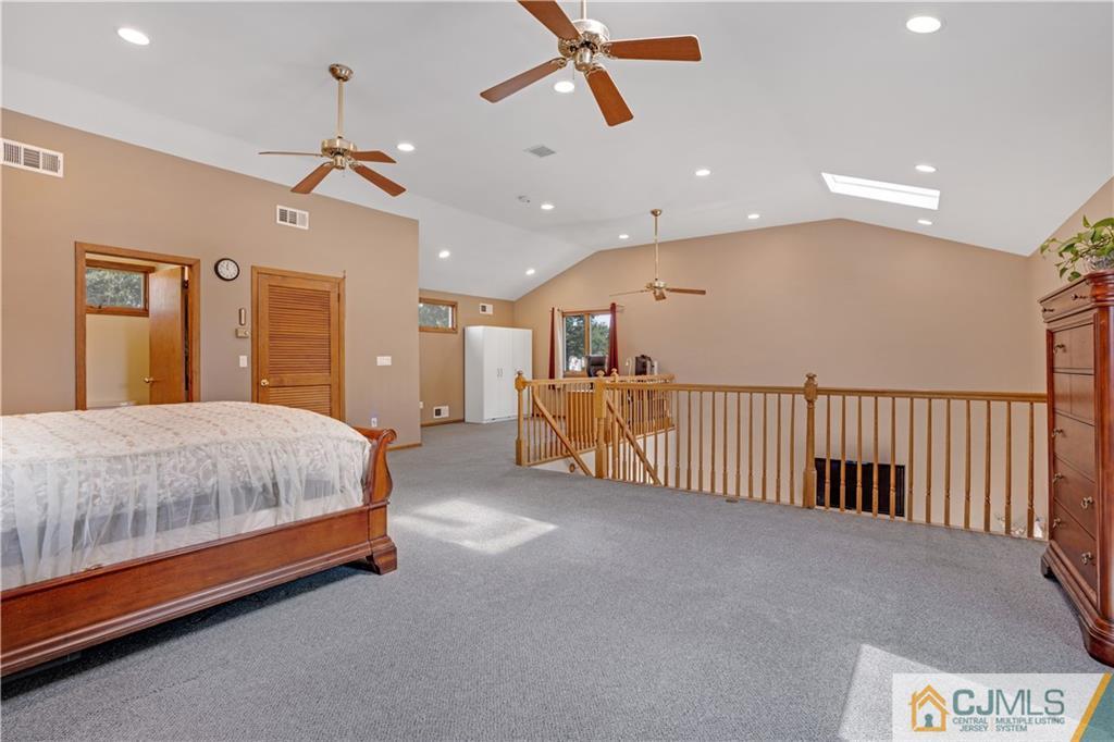 10 Crescent Road Edison, NJ 08817 - Photo 17 of 33 a spacious bedroom with a bed and a chandelier