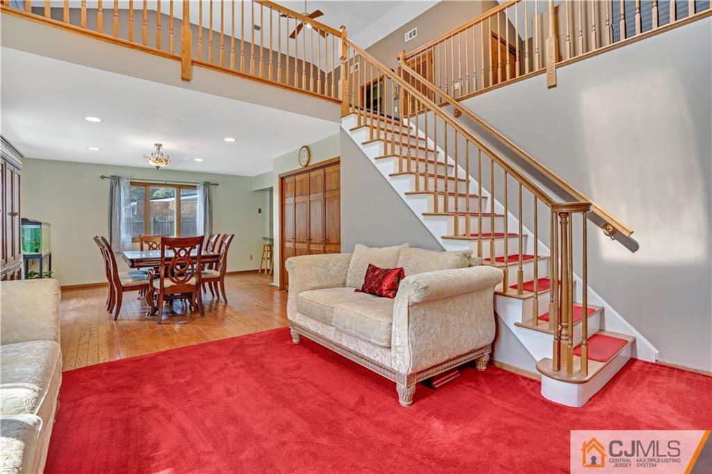 10 Crescent Road Edison, NJ 08817 - Photo 21 of 33 a living room with furniture and a dining table with rug