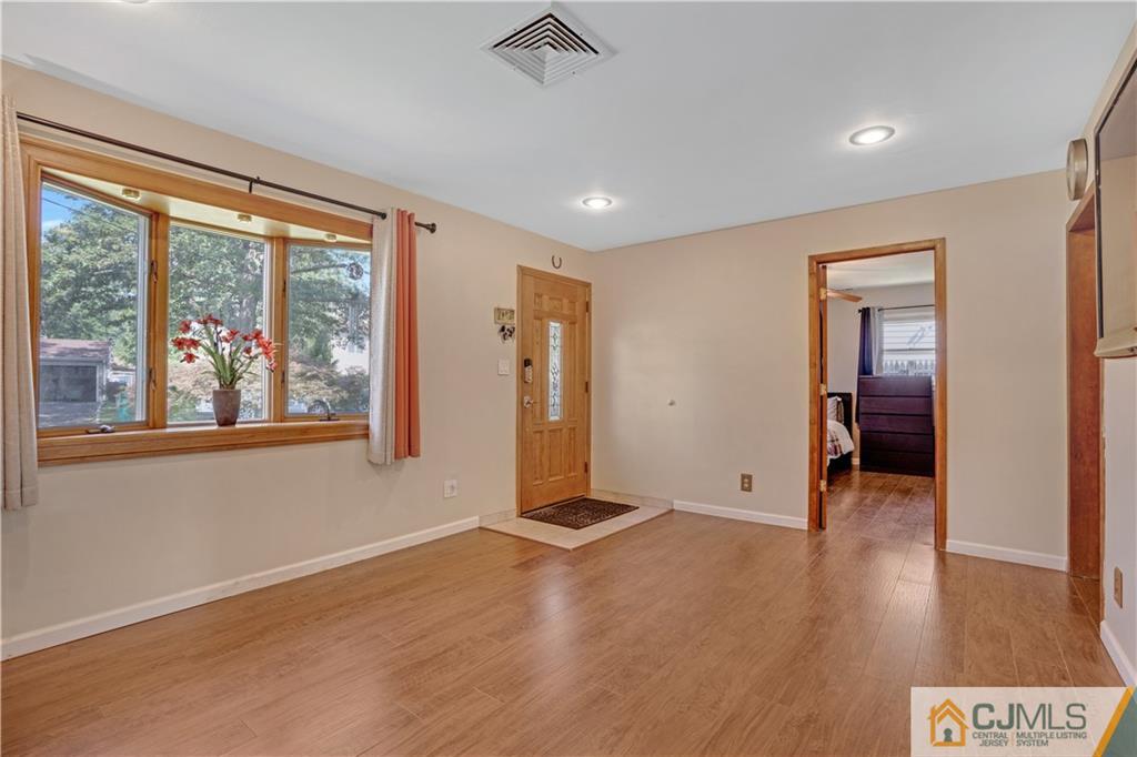 10 Crescent Road Edison, NJ 08817 - Photo 3 of 33 an empty room with wooden floor and windows