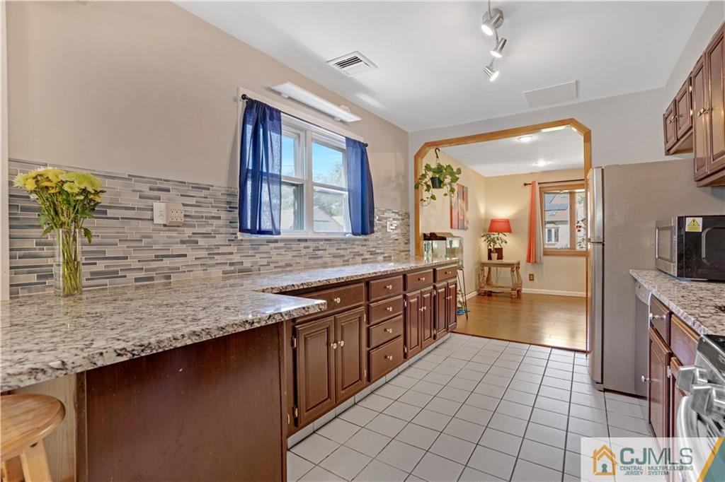 10 Crescent Road Edison, NJ 08817 - Photo 5 of 33 a large bathroom with a granite countertop double vanity sink a mirror and a