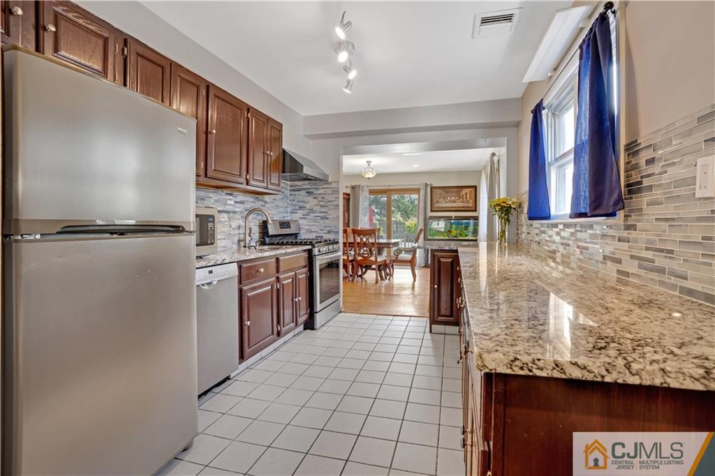 10 Crescent Road Edison, NJ 08817 - Photo 8 of 33 a kitchen with stainless steel appliances granite countertop a refrigerator a stove and a sink