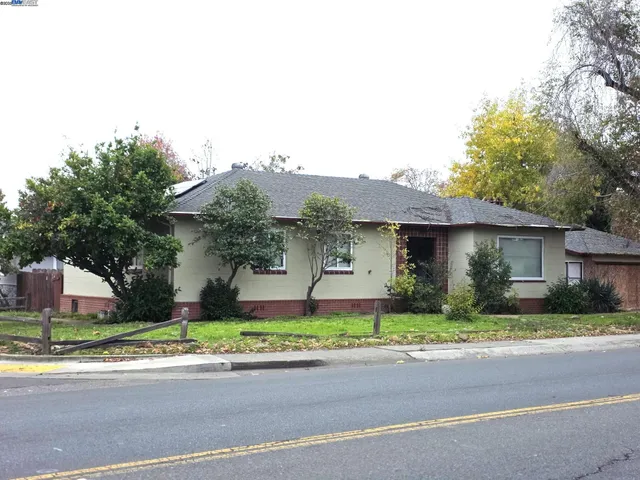a front view of a house with a garden and garage
