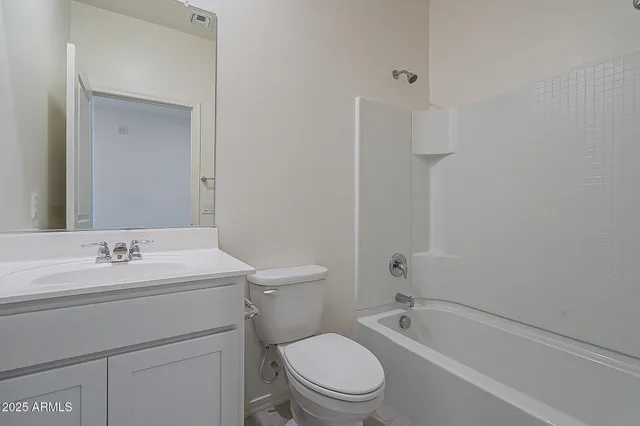 a bathroom with a toilet a sink and bathtub