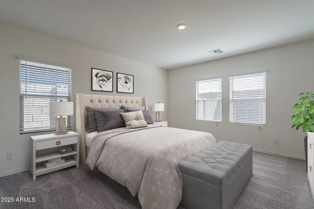 a spacious bedroom with a bed and a window